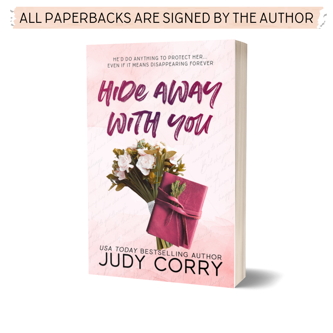 A object cover edition of the paperback for 'Hide Away With You' by Judy Corry, featuring a leather journal and a boquet of flowers.